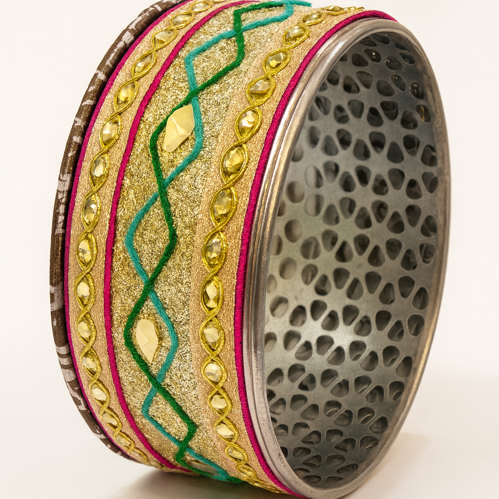 Decorative ring with gold, green, and pink patterns on a white background